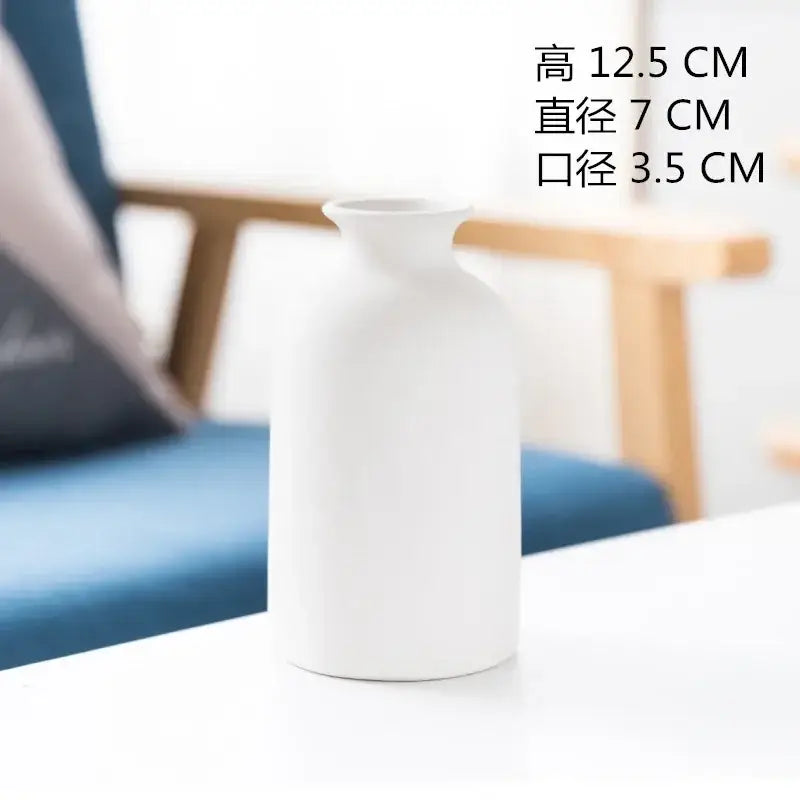 Minimalist white decorbites ceramic vase with smooth matte finish and gently curved body for dining room decor