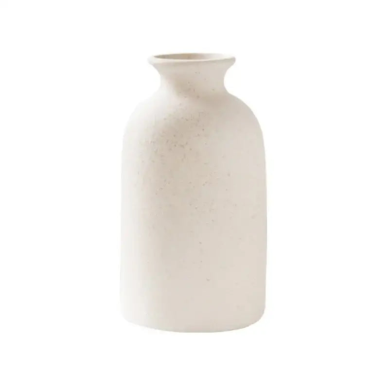 Cream-colored decorbites ceramic vase with subtle texture and curved silhouette for minimalist dining room decor