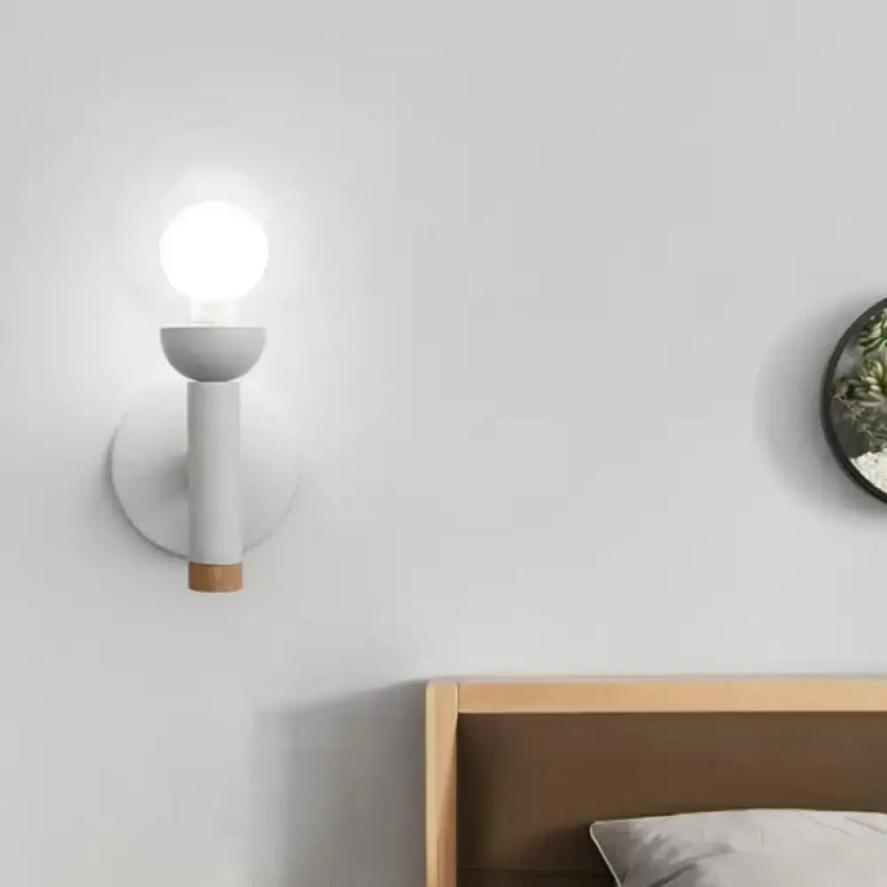Minimalist white and wood armed wall lamp with cylindrical stem and exposed bulb for 110v-120v bedroom use