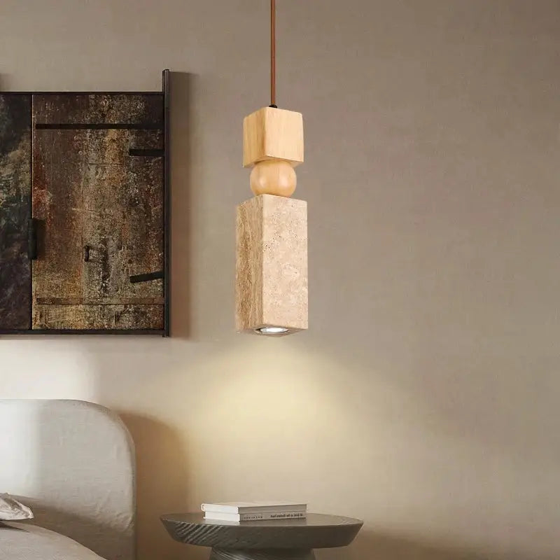 A minimalist wood and cuboid stone led pendant light with stacked geometric elements and copper-toned cord for dining room decorbites cuboid stone