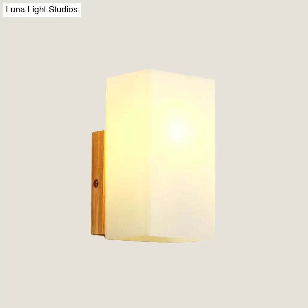 Minimalist wood and opal glass wall sconce with frosted glass shade and natural wood bracket for bedroom wall light