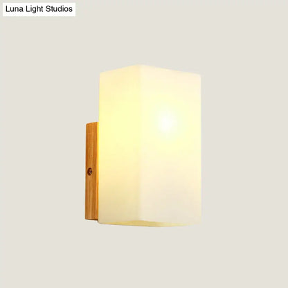 Minimalist wood and opal glass wall sconce with frosted glass shade and natural wood bracket for bedroom wall light