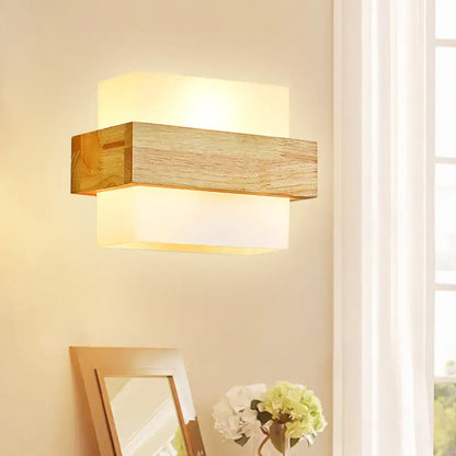 Minimalist wood and opal glass wall sconce with warm diffused glow for bedroom wall light illumination