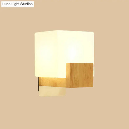 Minimalist wall sconce with frosted opal glass shade and natural wood accent for modern bedroom wall light