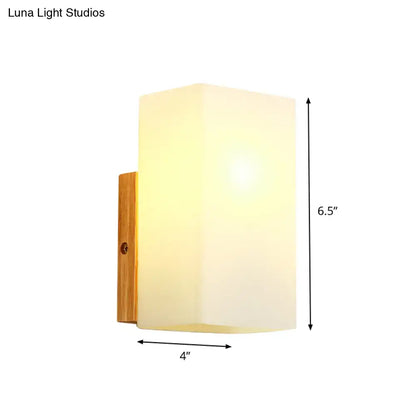Minimalist wall sconce with frosted opal glass shade and natural wood bracket for modern bedroom wall light