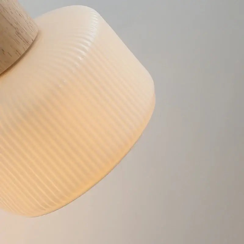 Minimalist decorbites led wall light with cream ribbed glass lampshade and natural wood stem for bedroom decor
