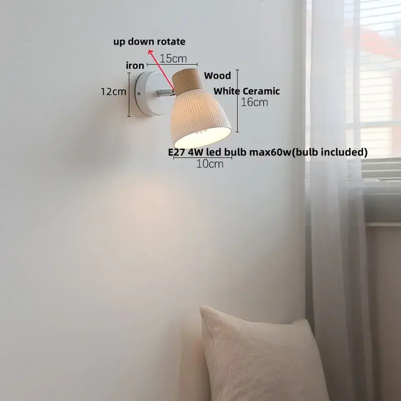 A minimalist decorbites led wall light with an iron base, wooden top, and white ceramic ridged shade for bedroom decor