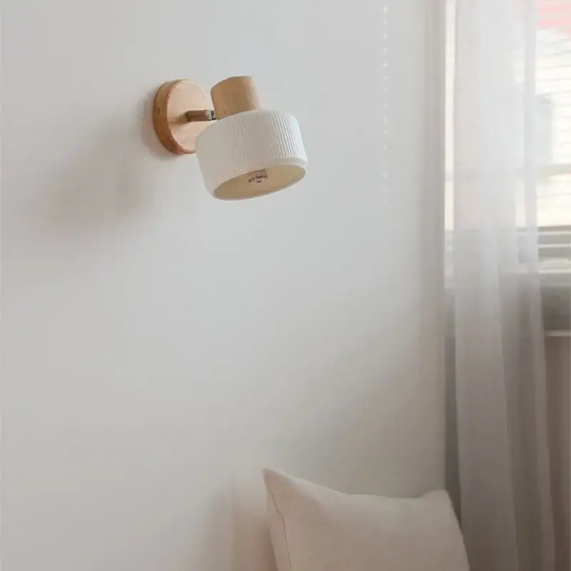 Minimalist wood and white ceramic led wall light with natural wood base and textured ceramic shade for bedroom decorbites led wall