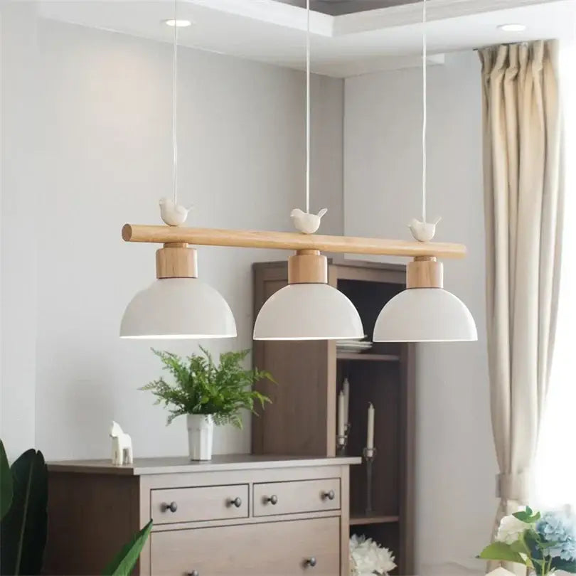 White ceramic decorbites bird light pendant with natural wood bar and three bird figurines for dining room decor
