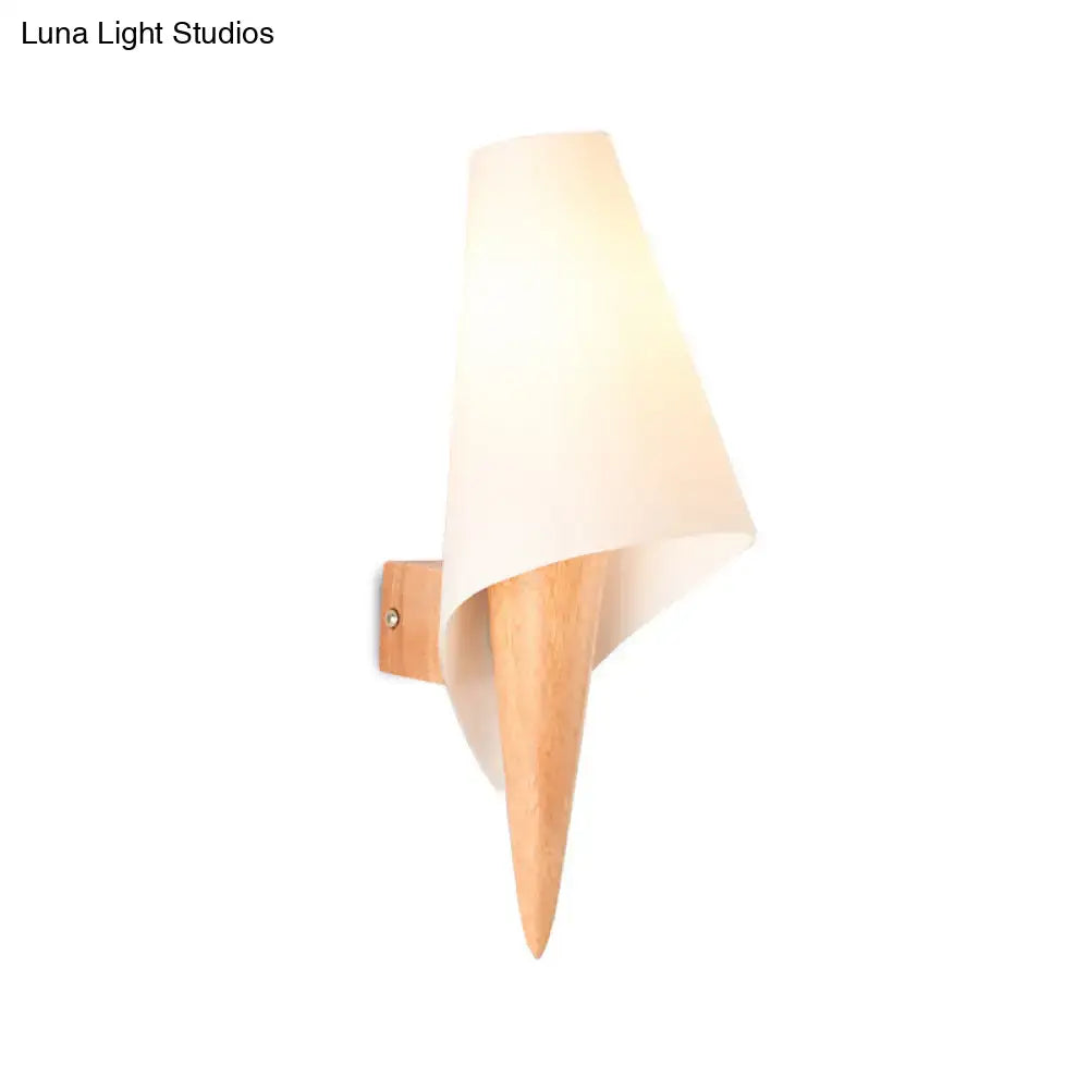 Minimalist wall-mounted light fixture with a tapered wooden base and off-white fabric shade for bedroom use