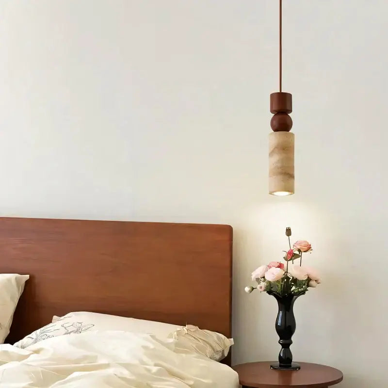 A modern minimalist pendant light with warm wood top and cylindrical led yellow travertine body for dining room decorbites LED yellow