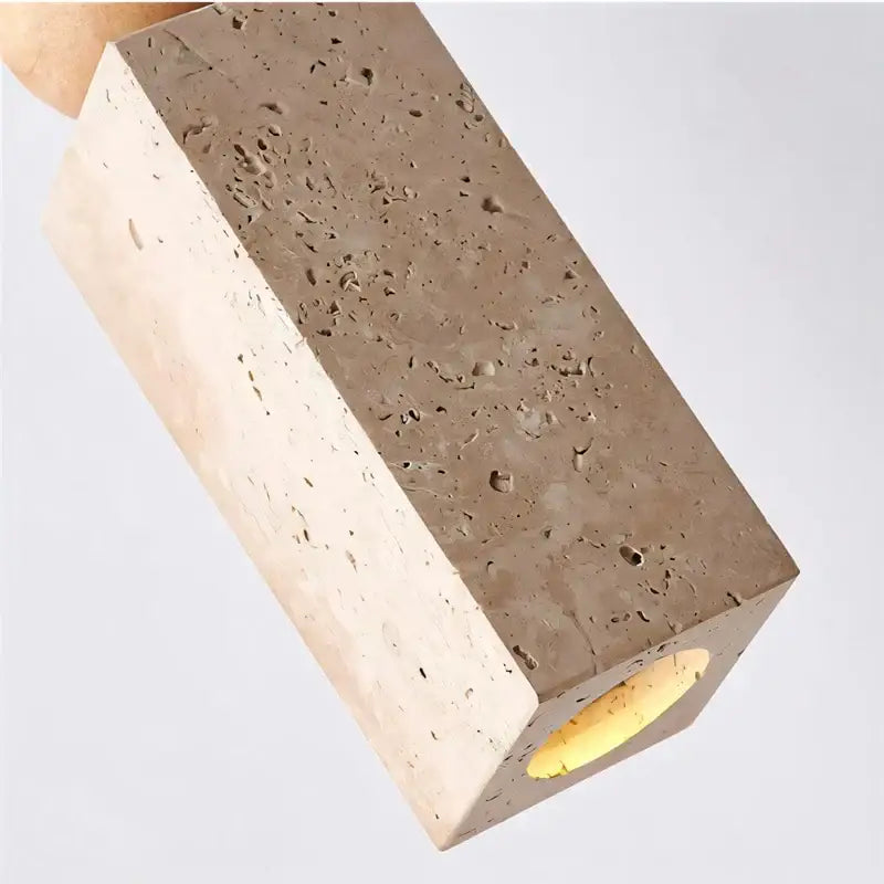 Minimalist rectangular concrete block lamp with speckled yellow travertine surface and warm led yellow travertine light for dining room