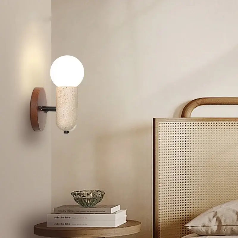 A modern led wall sconce with a matte white speckled glass globe and warm wood backplate for bedroom decorbites light