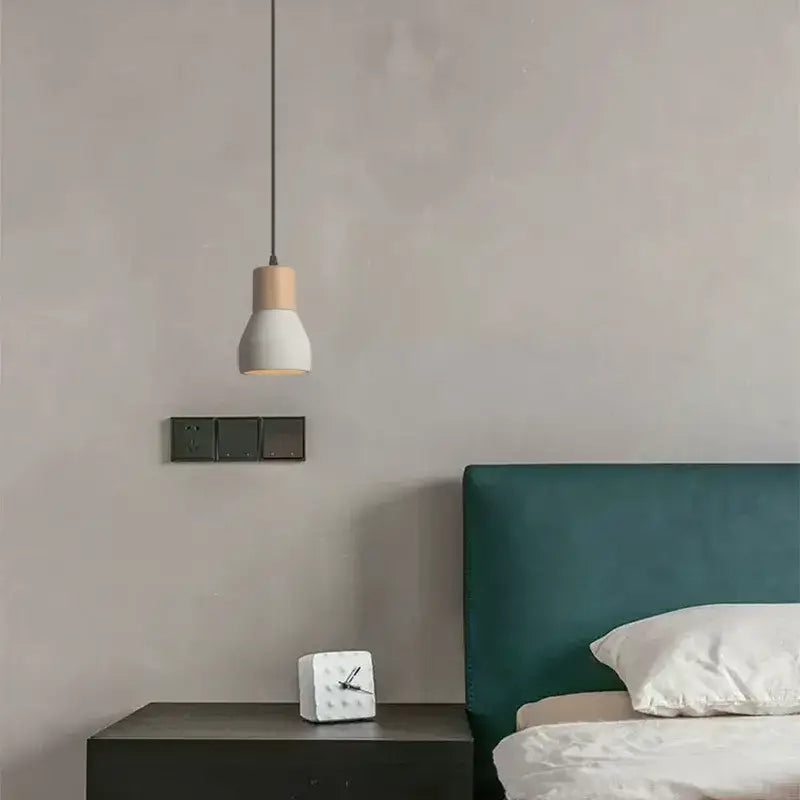 Minimalist pendant lamp with white ceramic shade and light wood top suspended by black cord for bedroom decorbites cement concrete
