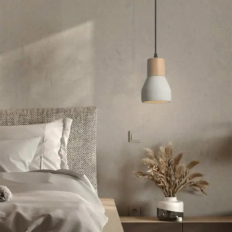 Minimalist wood and white ceramic pendant lamp with matte finish and black cord for bedroom decorbites cement concrete bedside