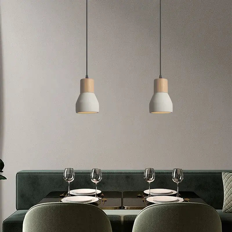 Two minimalist pendant lamps with matte white ceramic shades and wood accents for bedroom decorbites cement concrete style