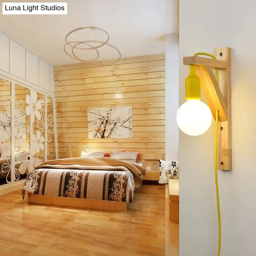 Minimalist yellow wooden wall sconce with round bulb and exposed cord featuring a medium base wall lamp for bedroom use