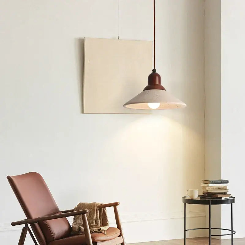 Minimalist yellow travertine stone pendant light with warm-toned matte concrete shade and dark wood metal top for dining room