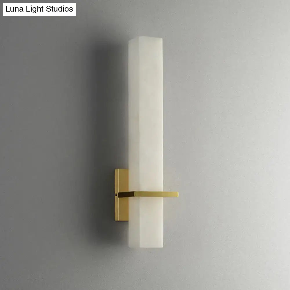 Modern minimalist wall sconce with frosted white glass shade and polished brass hardware for 110v-120v minimalistic marble wall use