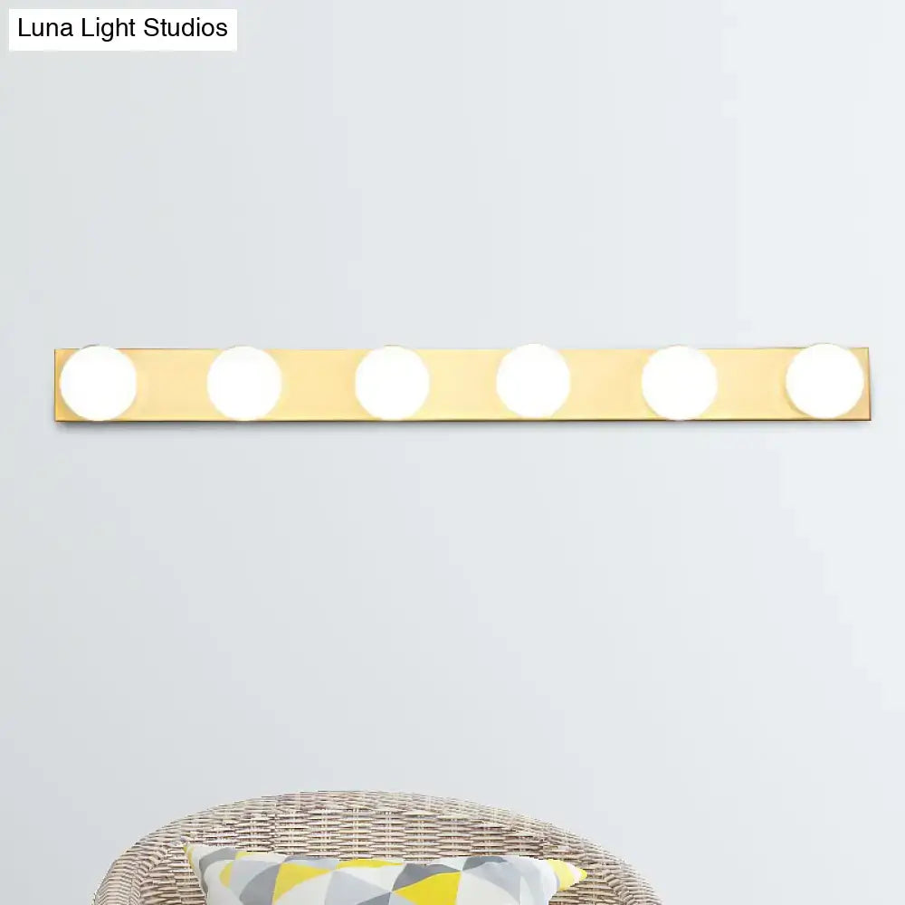 Gold-finished vanity lighting fixture with five open bulb lights for minimalistic bathroom vanity lighting