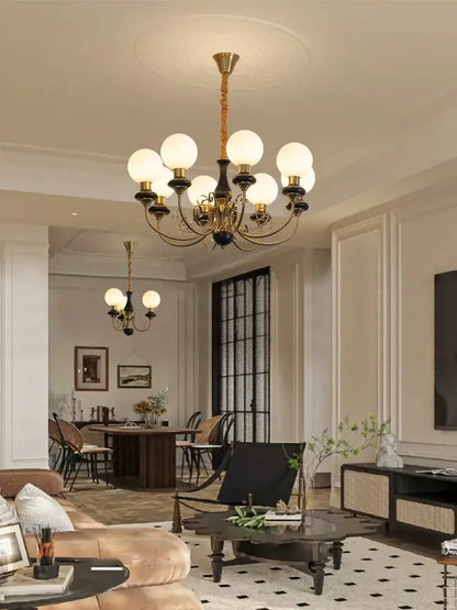 Gold-toned cream style led chandelier with frosted glass globes and black accents for dining room decorbites cream style