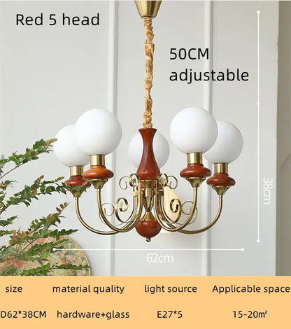 Vintage style led chandelier with brass finish, five white glass globes, and wooden accents for decorbites cream style lighting