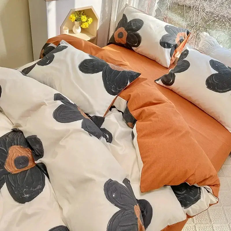 Cream-colored duvet cover and pillowcases with bold black and orange floral print cotton bedding set for bedroom