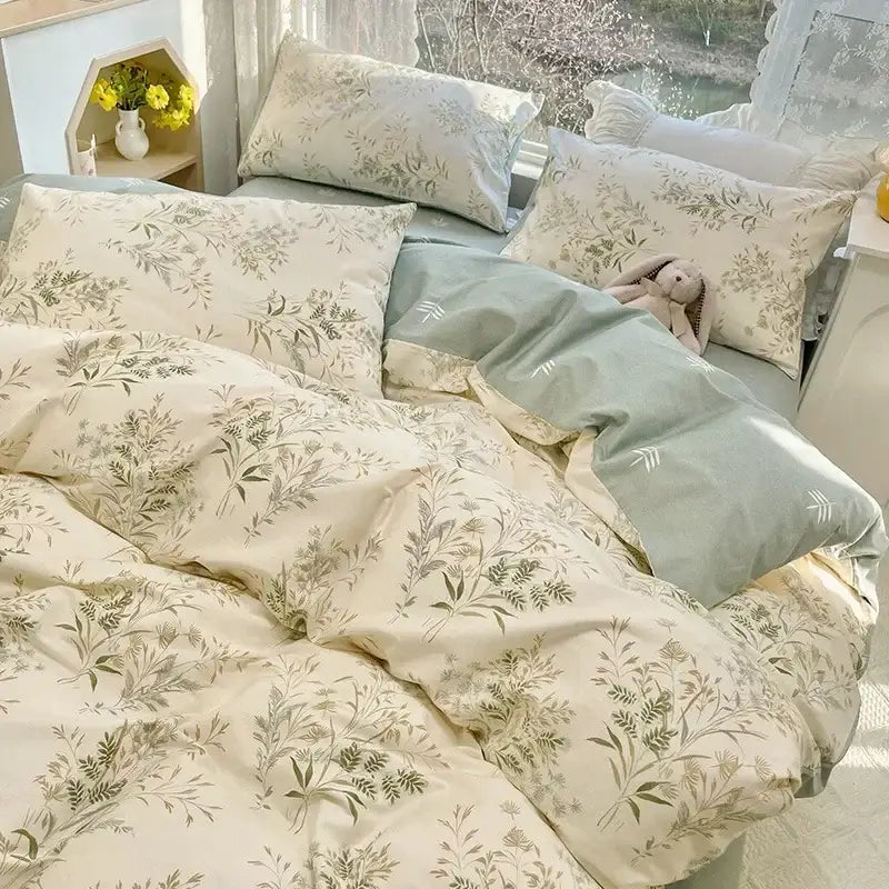 Cream-colored duvet cover with delicate green botanical prints in a floral print cotton bedding set for bedroom use