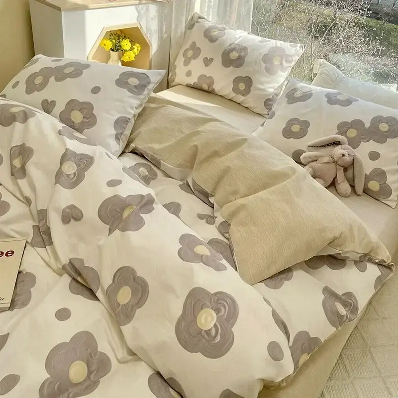A cozy cream-colored bedding set with soft floral print cotton featuring gray blossoms and yellow centers