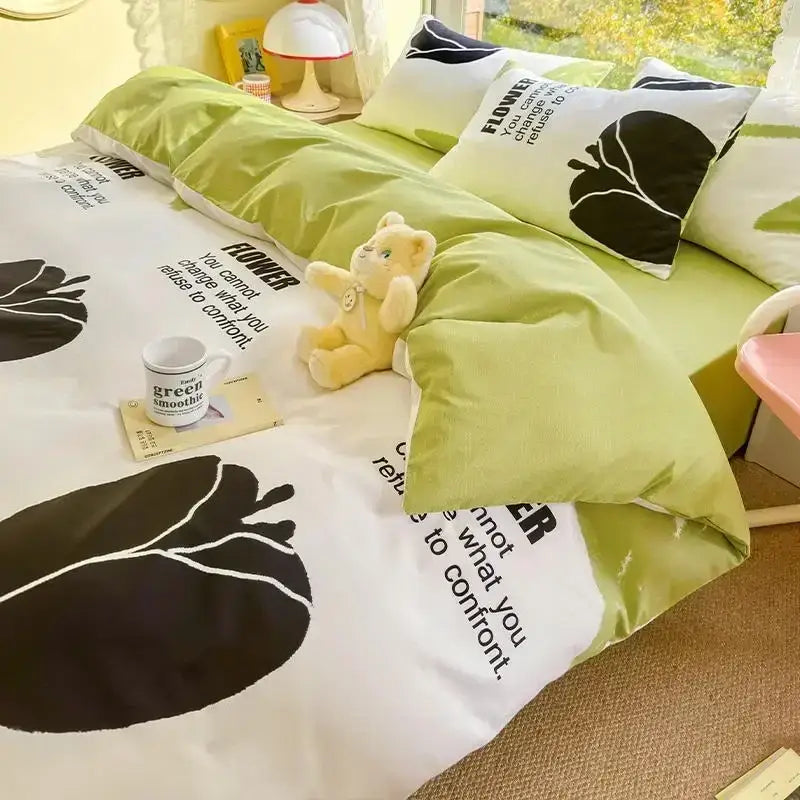 Mint and cream floral print cotton bedding set with lime green white flowers black leaf silhouettes and inspirational text
