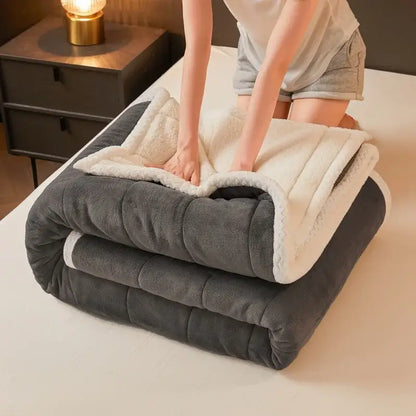 A plush dark gray and cream-colored mint and cream quilted coral fleece winter blanket by decorbites cozy