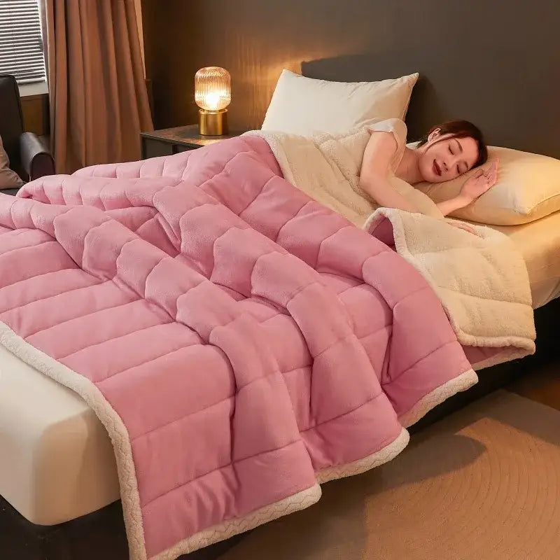 Pink quilted blanket with cream fleece lining featuring soft plush texture in decorbites cozy coral fleece winter bedding