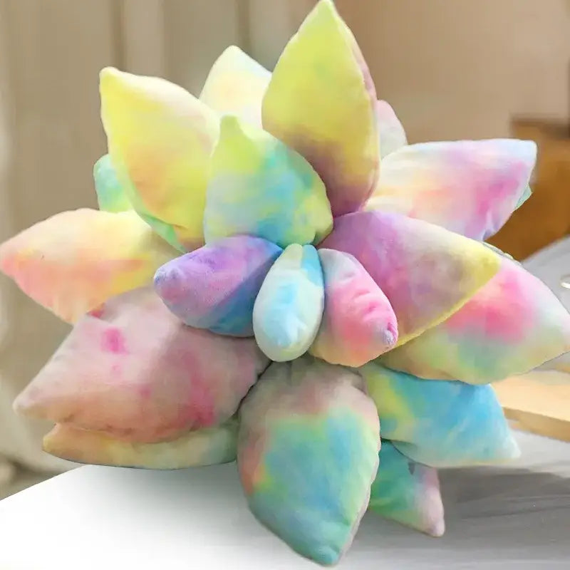 A plush tie-dyed succulent cactus pillow in soft pastel yellow pink blue and green perfect for living room decor