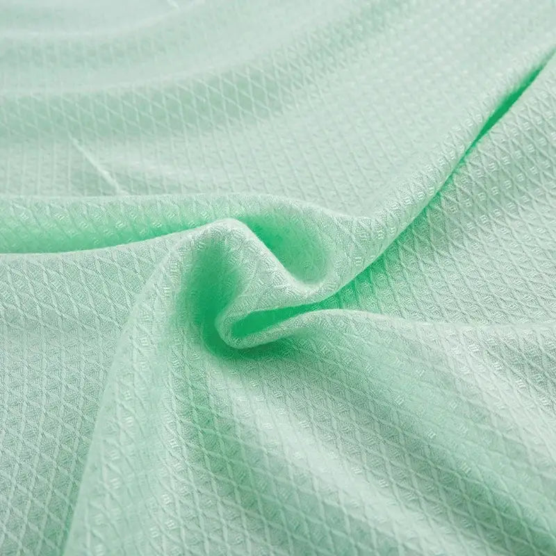 Light green textured bamboo fiber cooling summer blanket with subtle diamond pattern for bedroom use