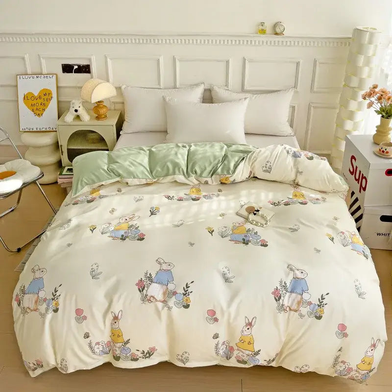 Cream-colored quilt bedding set featuring cartoon heart plant design with rabbits in pastel outfits and floral foliage