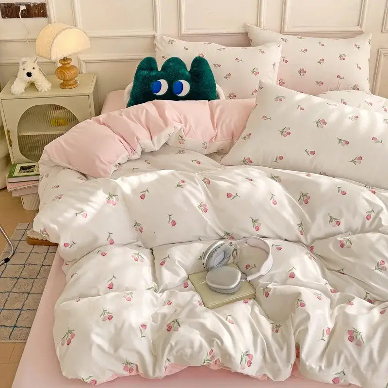 White duvet cover with pink cherry blossom prints and quilted texture from mint green and cream cartoon heart plant quilt set