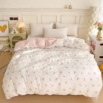 White duvet cover with delicate cherry print in soft pink and green featuring a cartoon heart plant design and subtle sheen