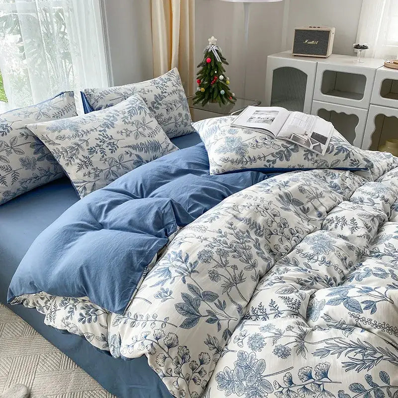 Mint green and cream cartoon heart plant quilt set with blue and white floral patterned soft quilted bedding