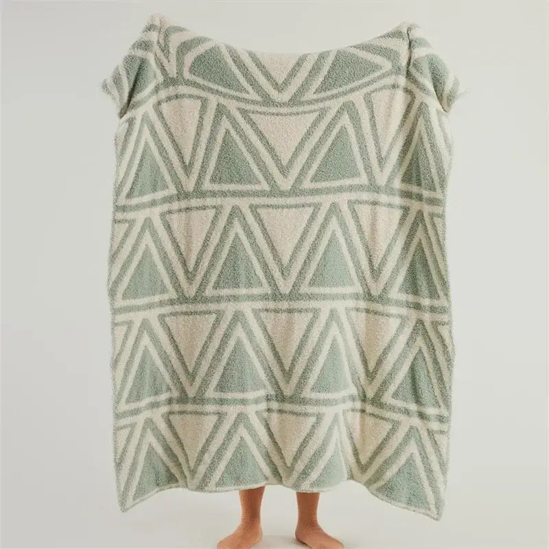 Soft plush mint green and cream knitted jacquard blanket with geometric interlocking triangles by decorbites