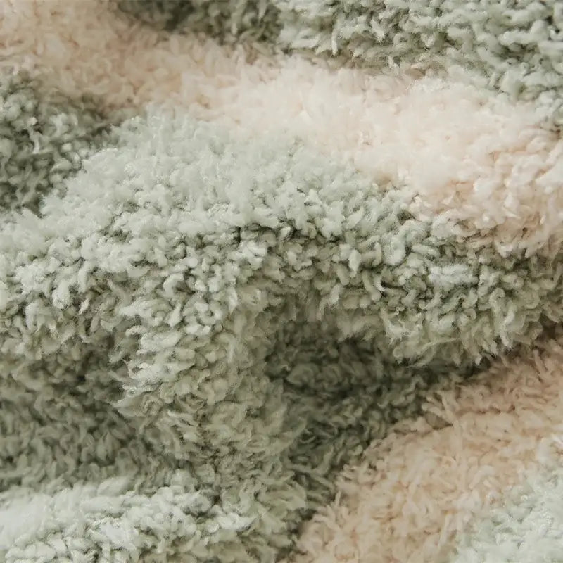 Soft plush decorbites knitted jacquard blanket in mint green and cream with cozy textured surface for bedroom throw