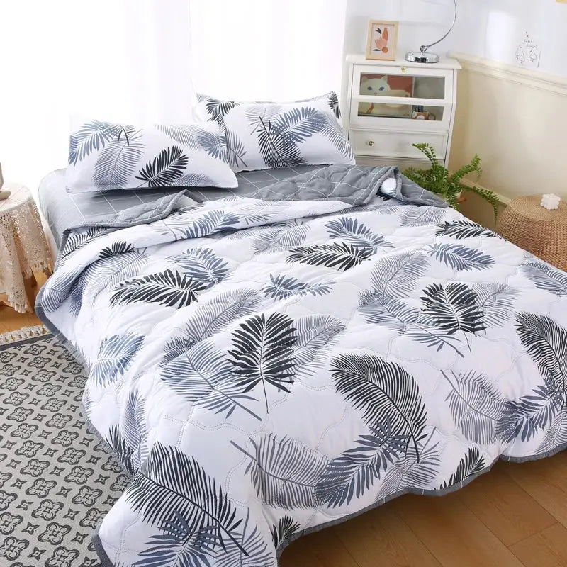 White quilted comforter with bold black and gray tropical leaf pattern in mint green daisy print quilt set decorbites daisy print