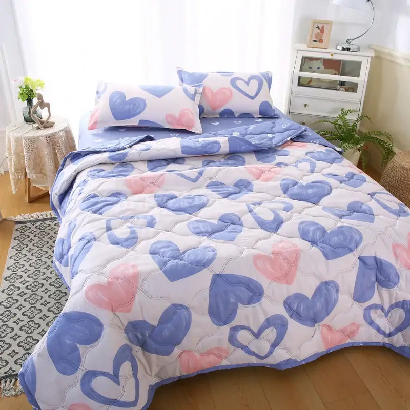 Quilt set featuring playful blue and pink heart pattern with stitched quilting on white fabric for decorbites daisy print bedding