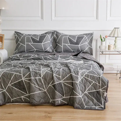 Gray quilted comforter with geometric white line pattern and matching pillowcases from decorbites daisy print quilt set