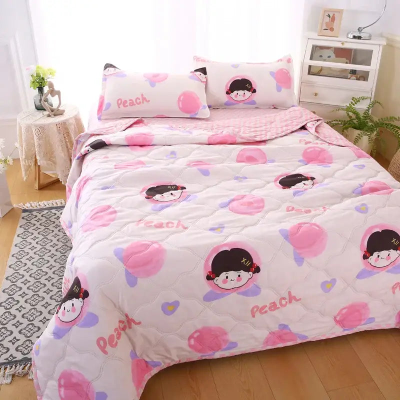 Pink and white quilt set with cartoon peach characters and light purple accents complementing decorbites daisy print