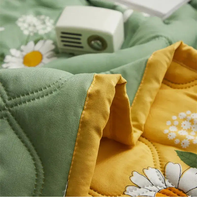 Soft green and yellow quilt set with embroidered daisy print featuring decorbites daisy print diamond quilting