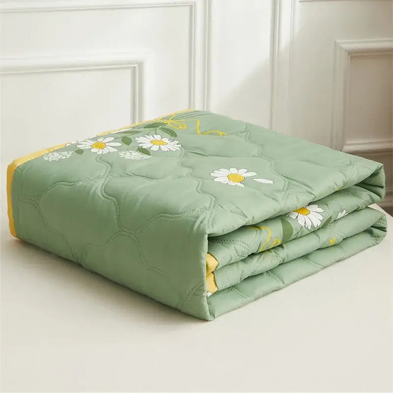 Mint green daisy print quilt set with delicate white daisies yellow centers and diamond quilted edges by decorbites