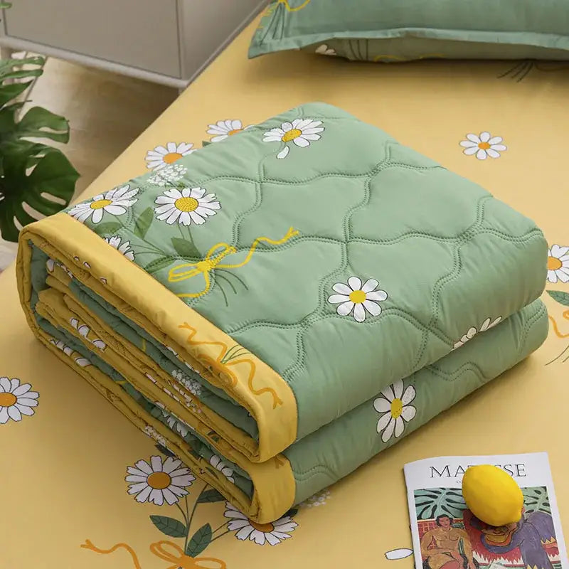 Mint green daisy print quilt set with diamond quilting and yellow trim providing warmth and texture by decorbites