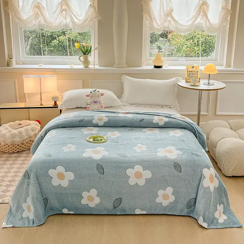 A soft light blue fleece blanket with white daisies and green leaves pattern for decorbites dinosaur patterns snowflake decor