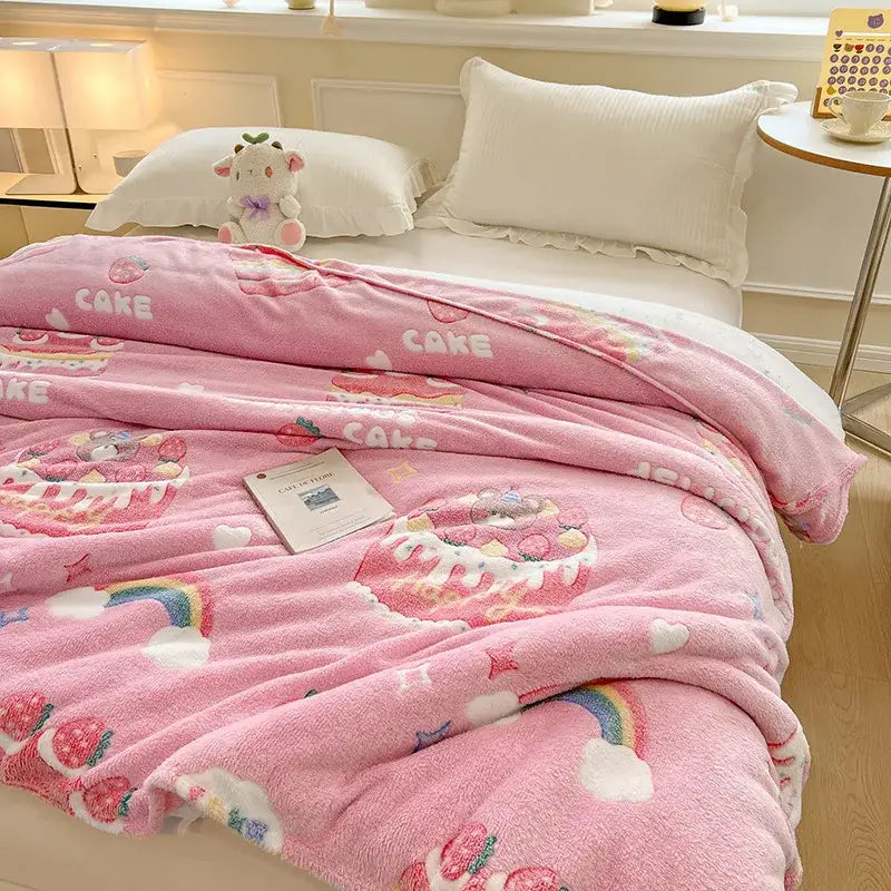 Pink plush blanket with playful cake rainbow and strawberry pattern paired with mint green dinosaur patterns snowflake velvet decorbites decor