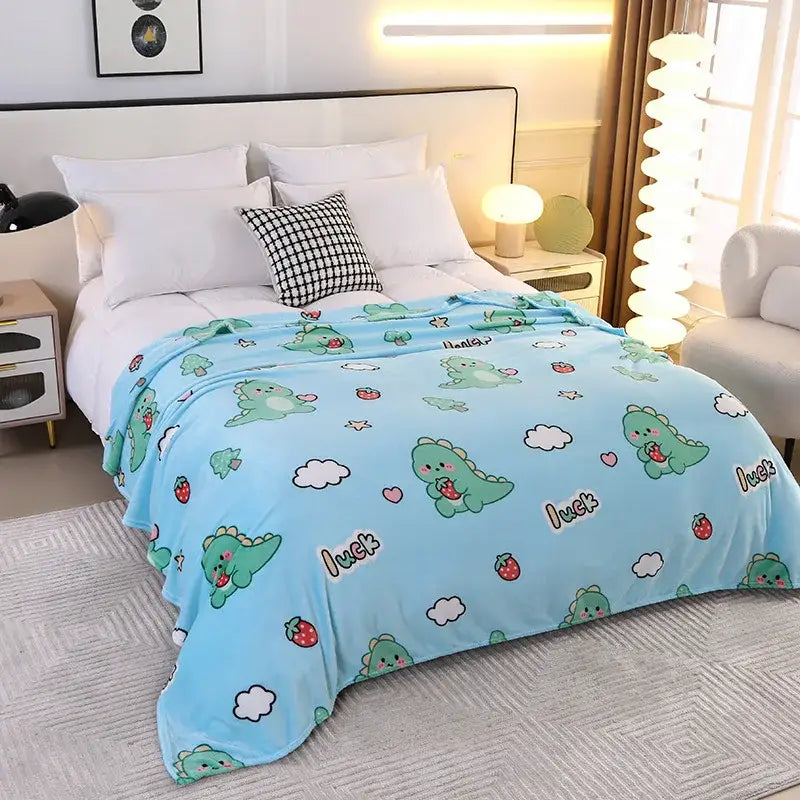 Mint green snowflake velvet blanket with light blue plush side featuring playful decorbites dinosaur patterns and strawberries